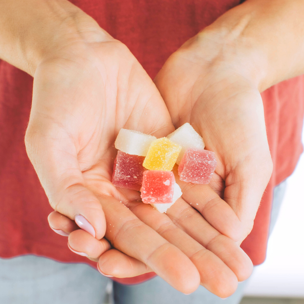 Hands holding gummies from the Mystery Blend | Gold Leaf Collection | Delta-8 gummies by Lake Country Growers | Mystery Blend, 18 count pack | 25mg per gummy in a variety of random flavors